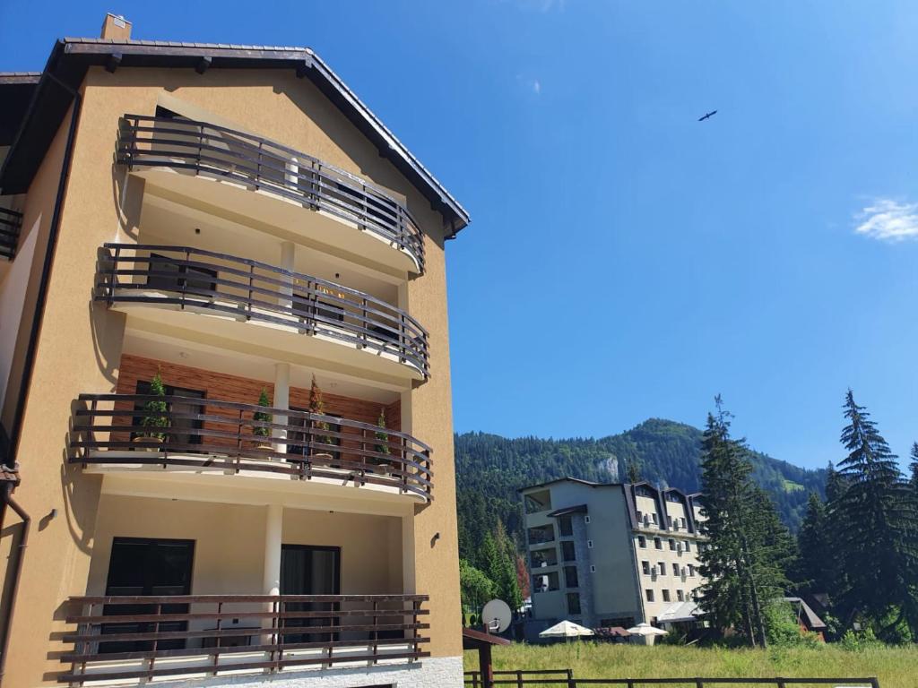 a building with balconies on the side of it at Apartament Ozon Poiana Brasov in Poiana Brasov