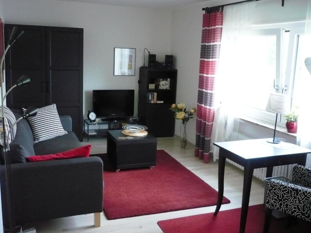 a living room with a couch and a red rug at Ferienwohnung Meindl 2 in Idar-Oberstein