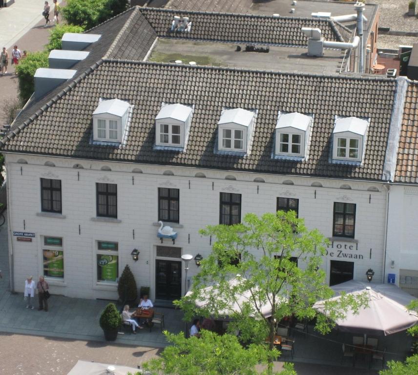 an overhead view of a white building with white windows at Square Boutique Hotel & Brasserie in Venray