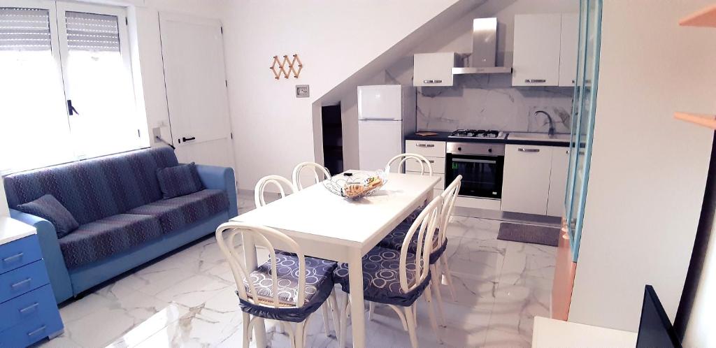 een keuken en een woonkamer met een tafel en stoelen bij Il fortino in Otranto