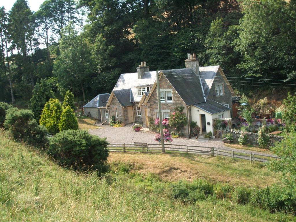 a large house with a fence in front of it at Willowherb and Foxglove Cottages Hawick in Hawick