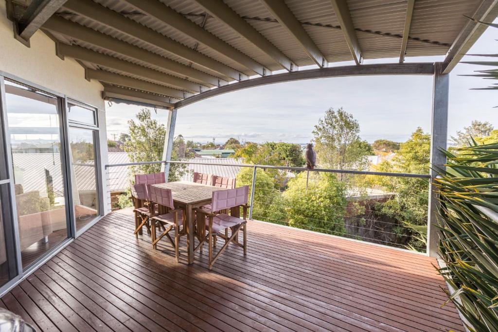 a patio with a table and chairs on a deck at Aqua Vista in Paynesville