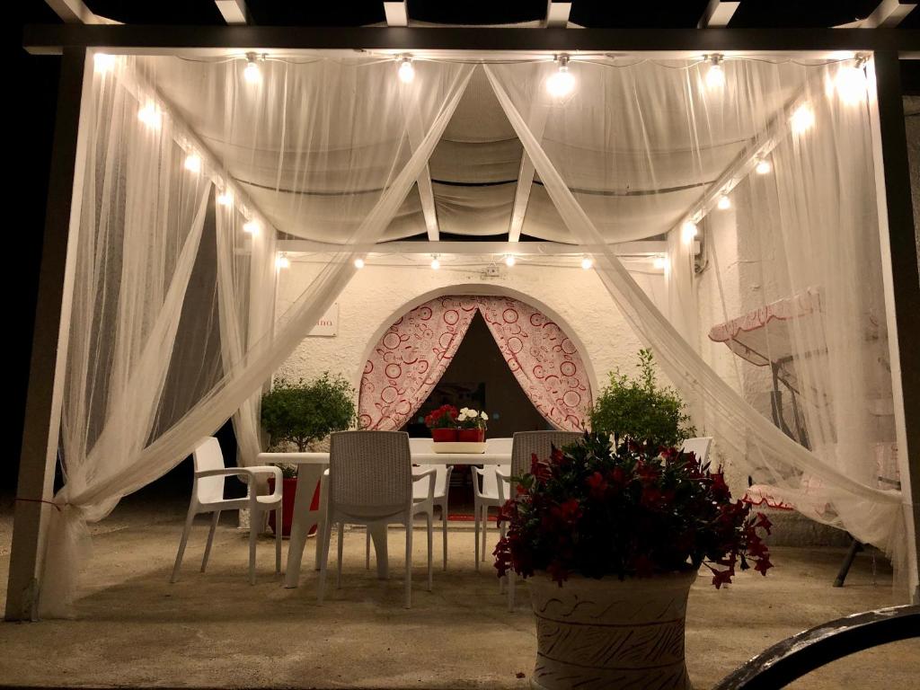 a table and chairs in a room with a tent at Villa Cenzina in Marina di Pisticci
