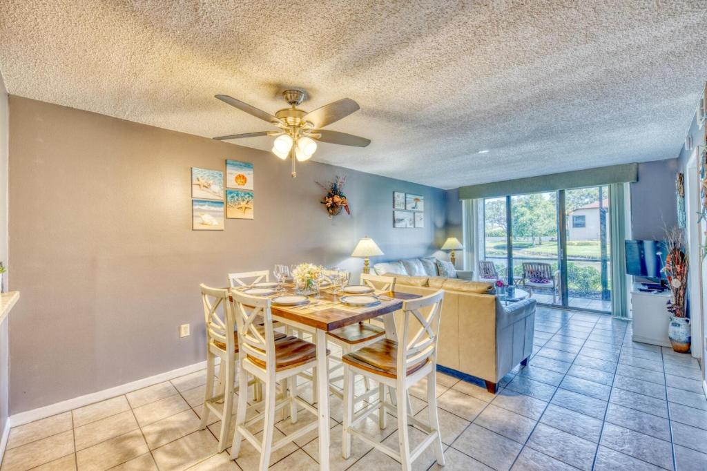 a dining room and living room with a ceiling fan at Shorewalk Full Condo Lake view Near to Beach IMG in Bradenton