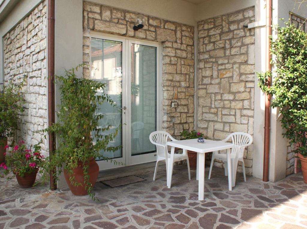 a white table and chairs on a patio at Affittacamere La Buganvillea in Numana