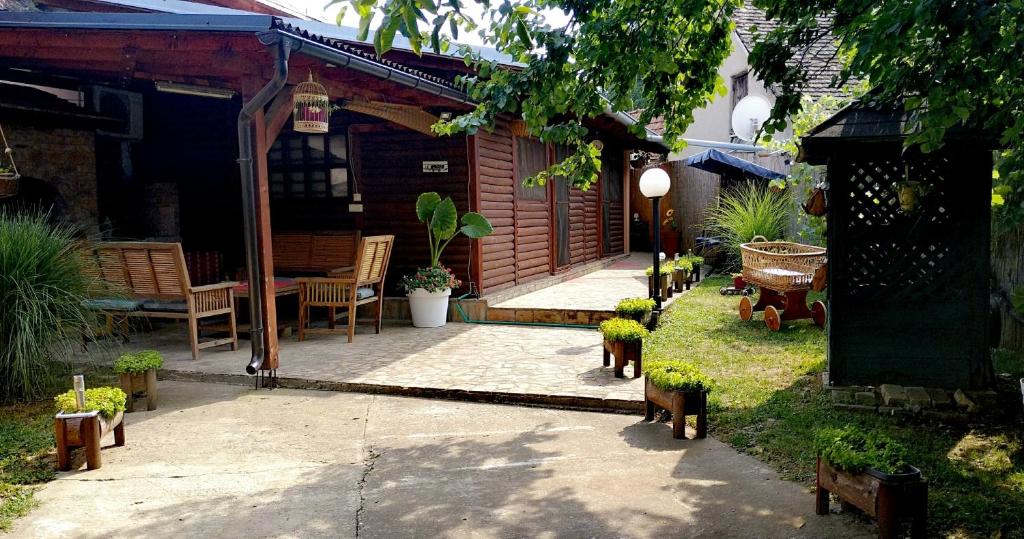 a patio with a table and chairs in a yard at Tera Nova in Vrdnik