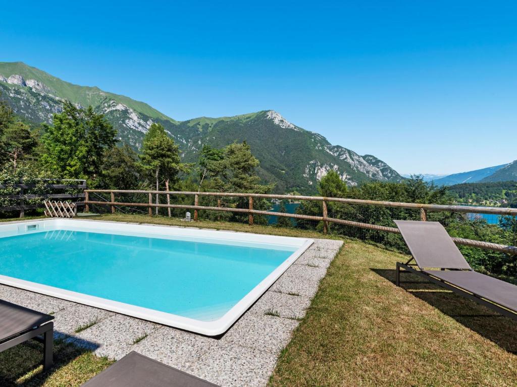 a swimming pool with a view of the mountains at Nice apartment with terrace just steps from the beach in Ledro