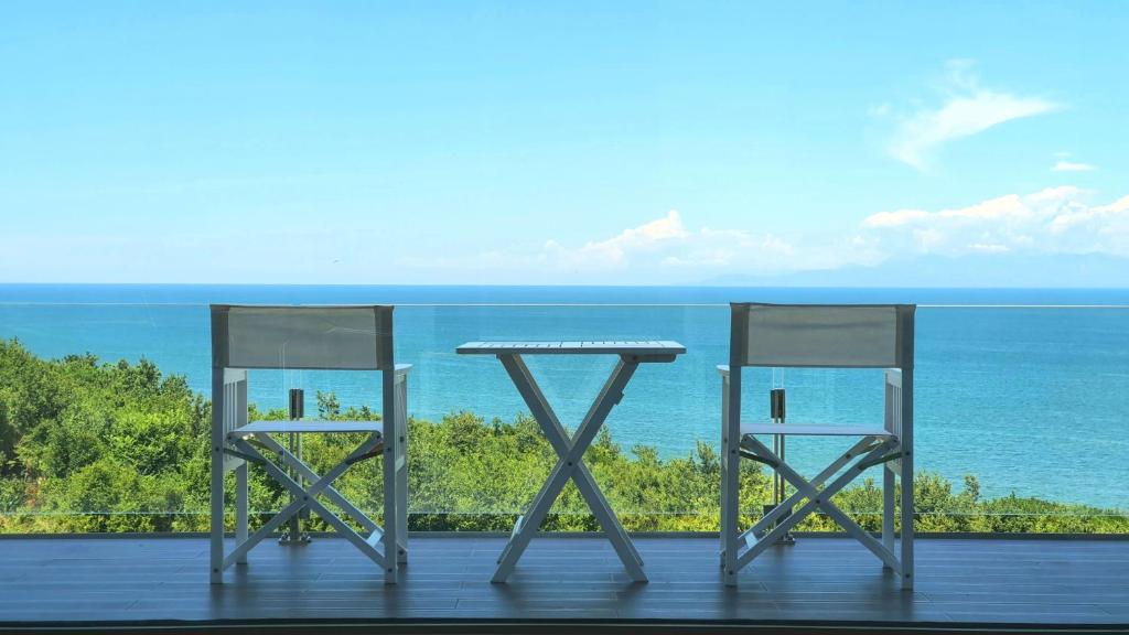 a table and two chairs on a balcony with the ocean at Duplex Seaview Condo in Durrës