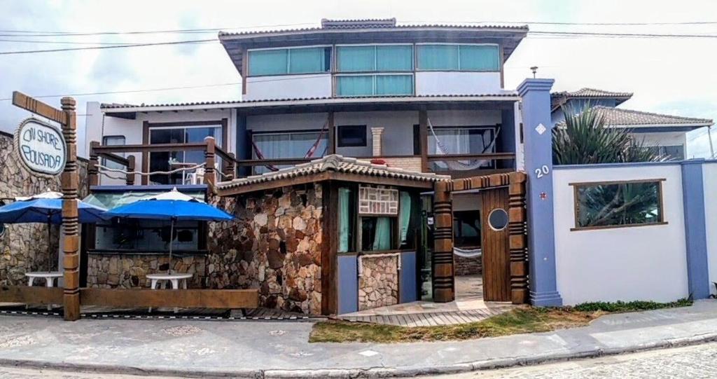 a building with a restaurant in front of it at Pousada On Shore in Cabo Frio