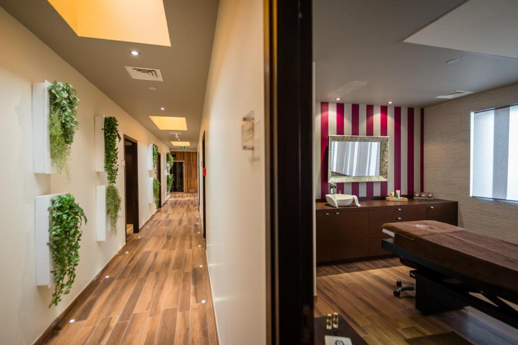 a corridor of a hospital room with a piano and a mirror at Saint Georges Hotel &amp; Spa in Chalon-sur-Saône