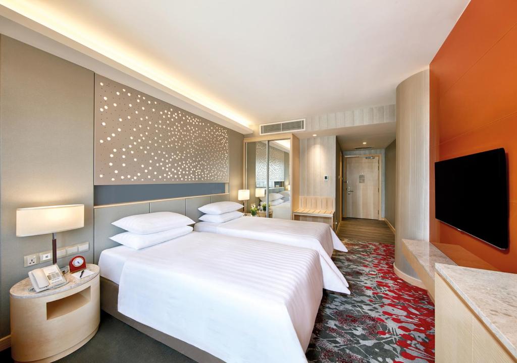 Postel nebo postele na pokoji v ubytování Sunway Pyramid Hotel