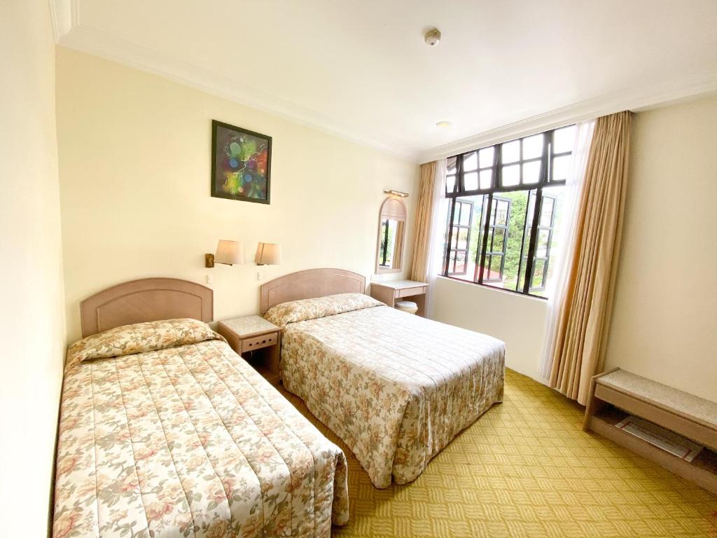 Katil atau katil-katil dalam bilik di Hotel Rainbow
