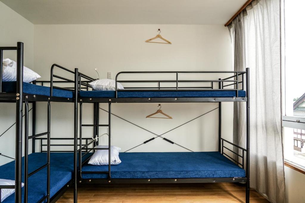 Postel nebo postele na pokoji v ubytování Arashima Hostel