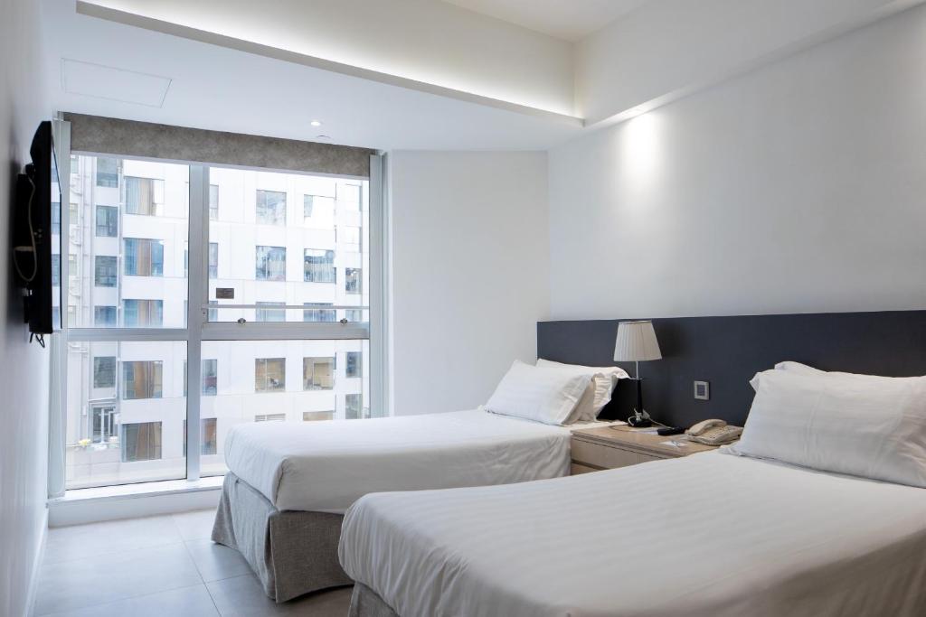 Postel nebo postele na pokoji v ubytování Wifi Boutique Hotel