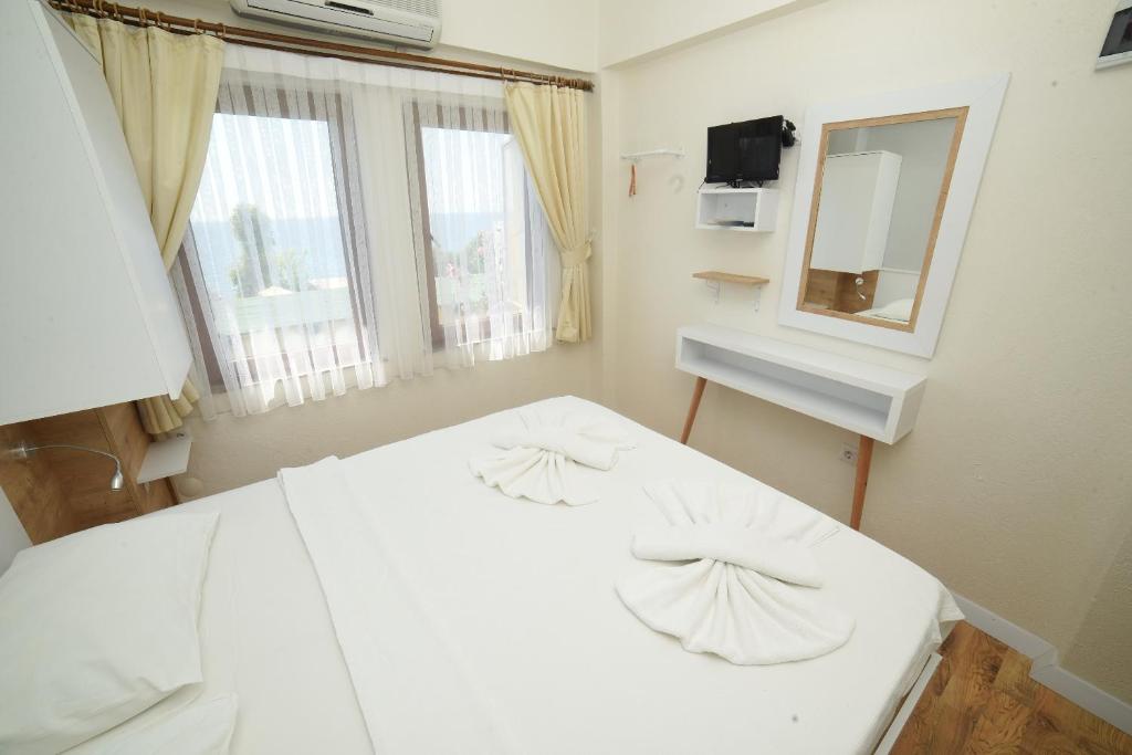 Postel nebo postele na pokoji v ubytování Limonata Hotel Assos