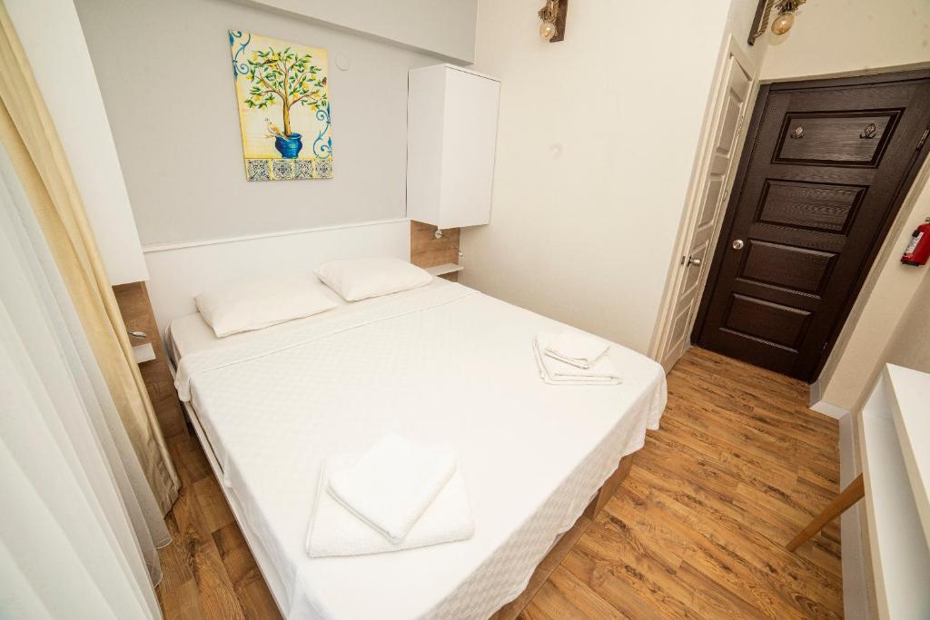 Postel nebo postele na pokoji v ubytování Limonata Hotel Assos