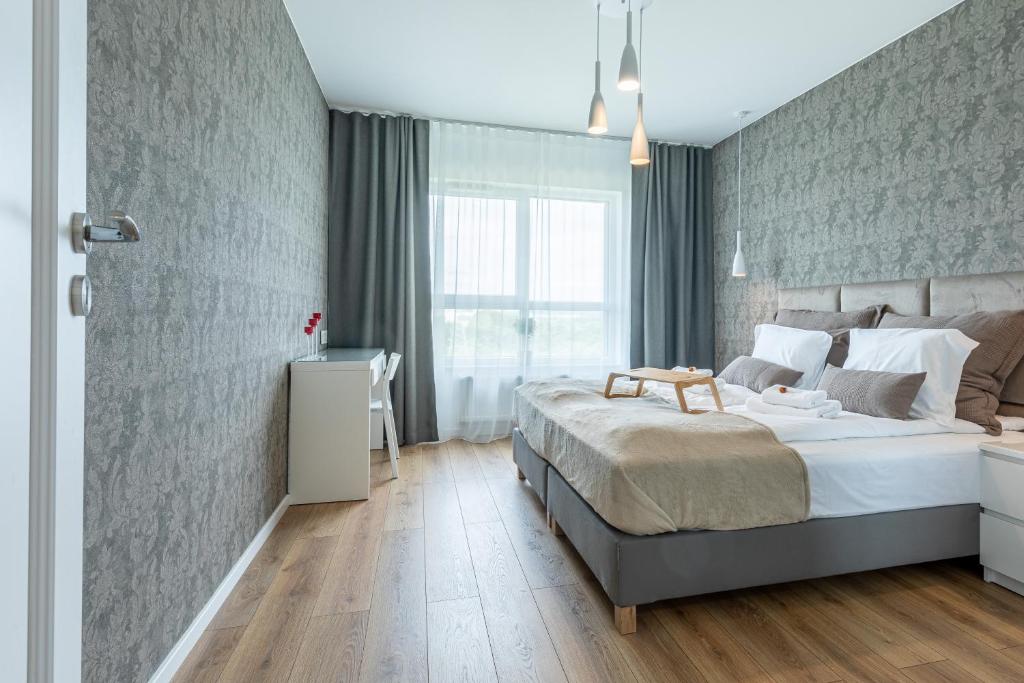 מיטה או מיטות בחדר ב-Symphony Baltica Towers Aparthotel