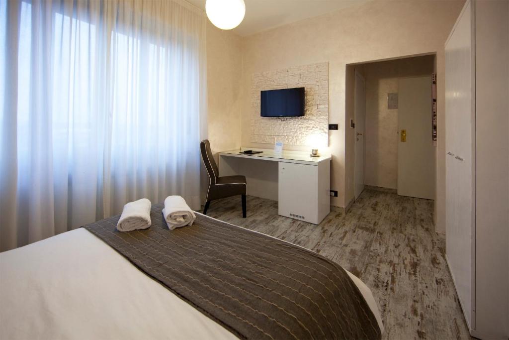 Postel nebo postele na pokoji v ubytování Piccolo Hotel Allamano
