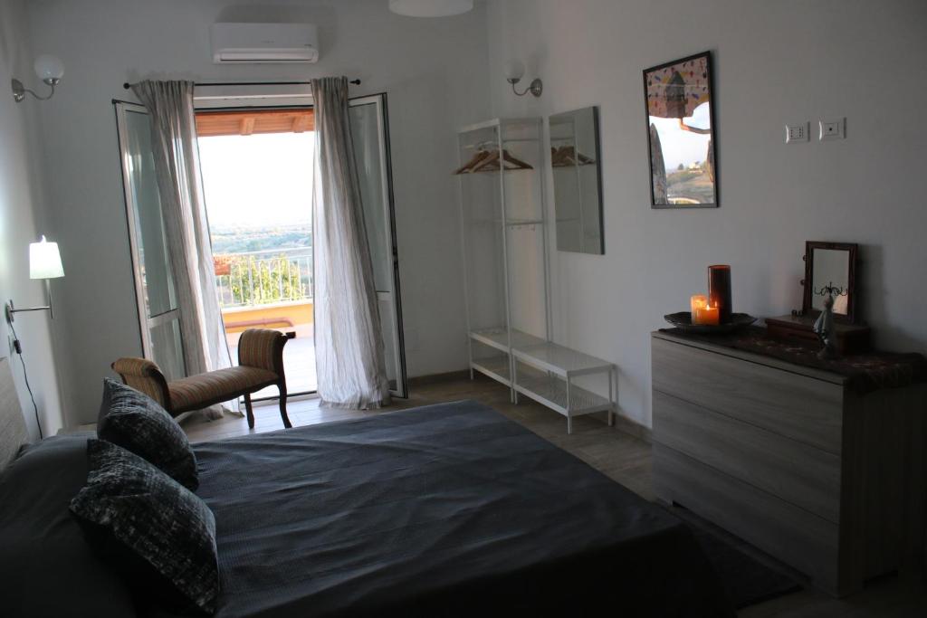 a bedroom with a bed and a large window at Belvedere Sasso in Sasso