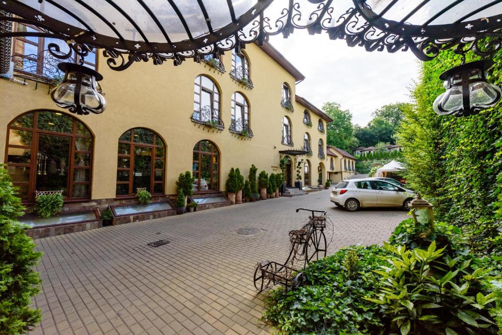 a street with a car parked in front of a building at Pension Passion in Târgu-Mureş