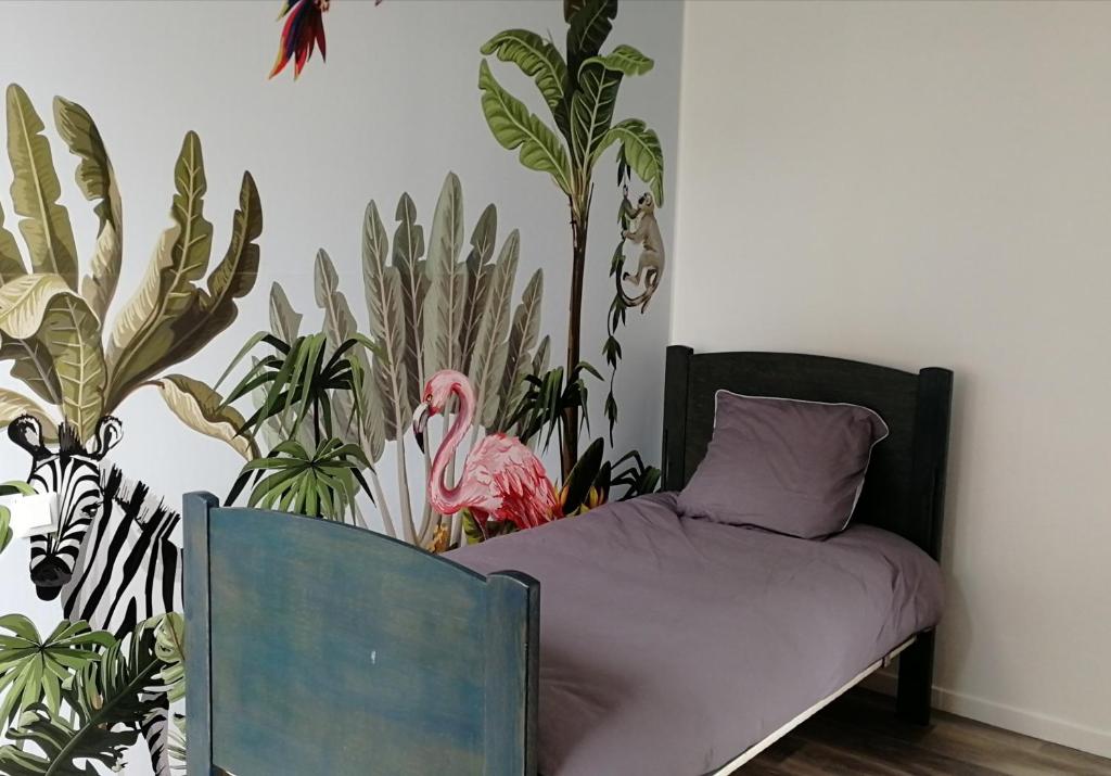 a bedroom with a bed and some plants at Le coryphée : Appartement en centre ville à Abbeville in Abbeville