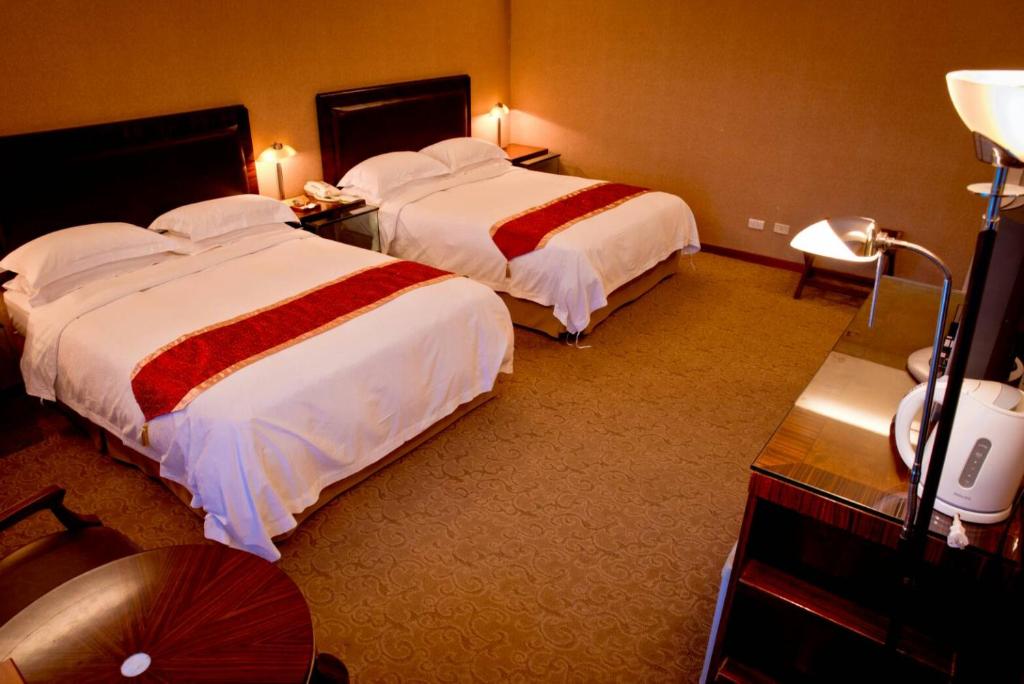 Postel nebo postele na pokoji v ubytování Resort One Hotel