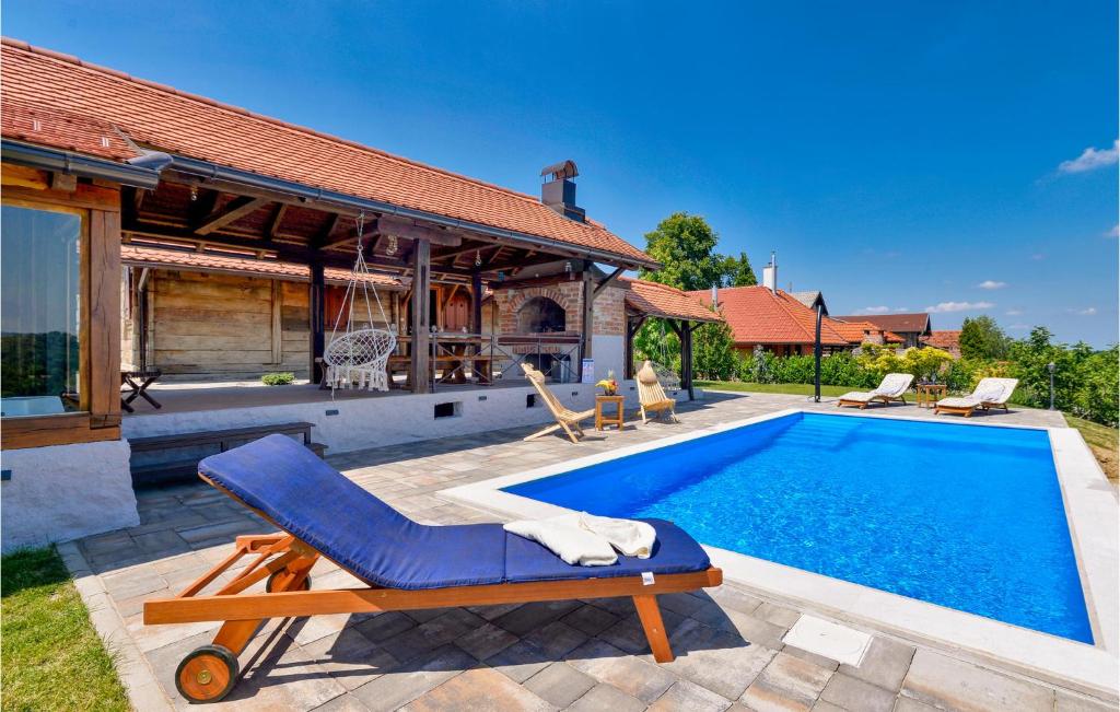 a pool with a lounge chair next to a house at Gorgeous Home In Martinkovec With Sauna in Jarki Horvatićevi