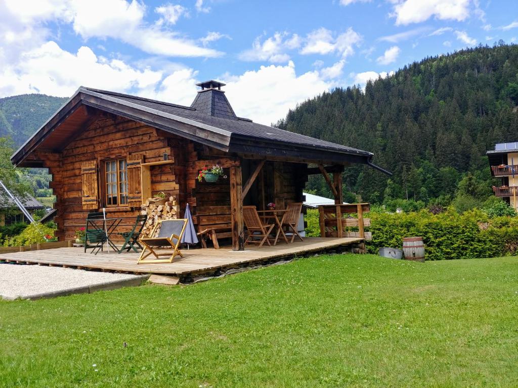 a log cabin with a porch and a deck at Chalet Le Marmouzet in Les Houches
