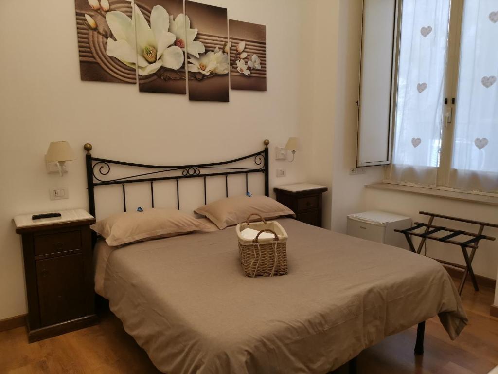 Napoli Pietrasanta LT في نابولي: غرفة نوم بها سرير مع سلة عليه