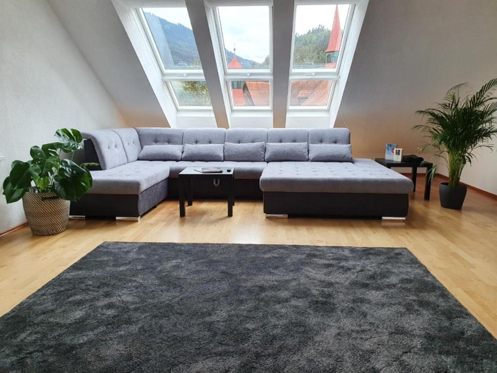 a living room with a couch and a rug at Dachgeschoss-Apartment in Landeck - 140m² in Landeck