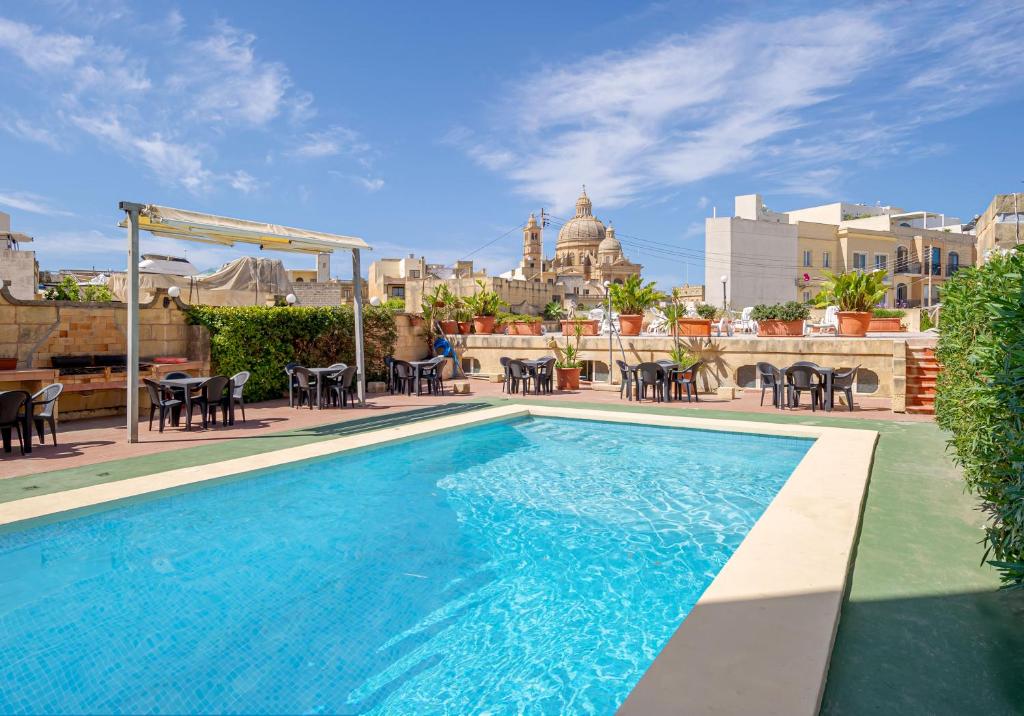 a swimming pool on the roof of a building at Mariblu Hotel in Xewkija