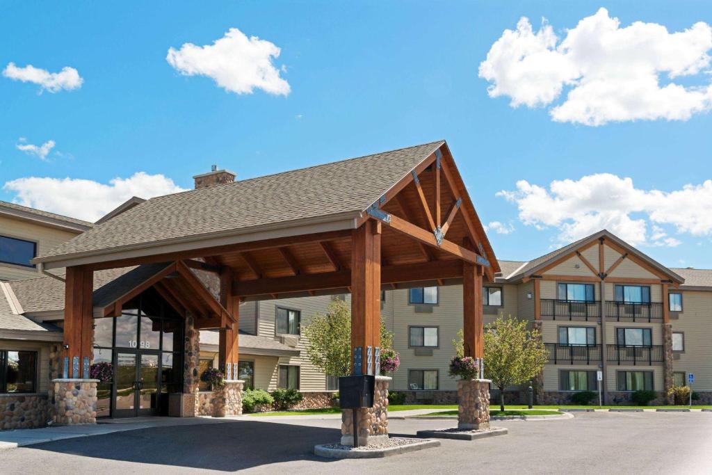 a pavilion in a parking lot in front of a building at AmericInn by Wyndham Rexburg BYUI in Rexburg