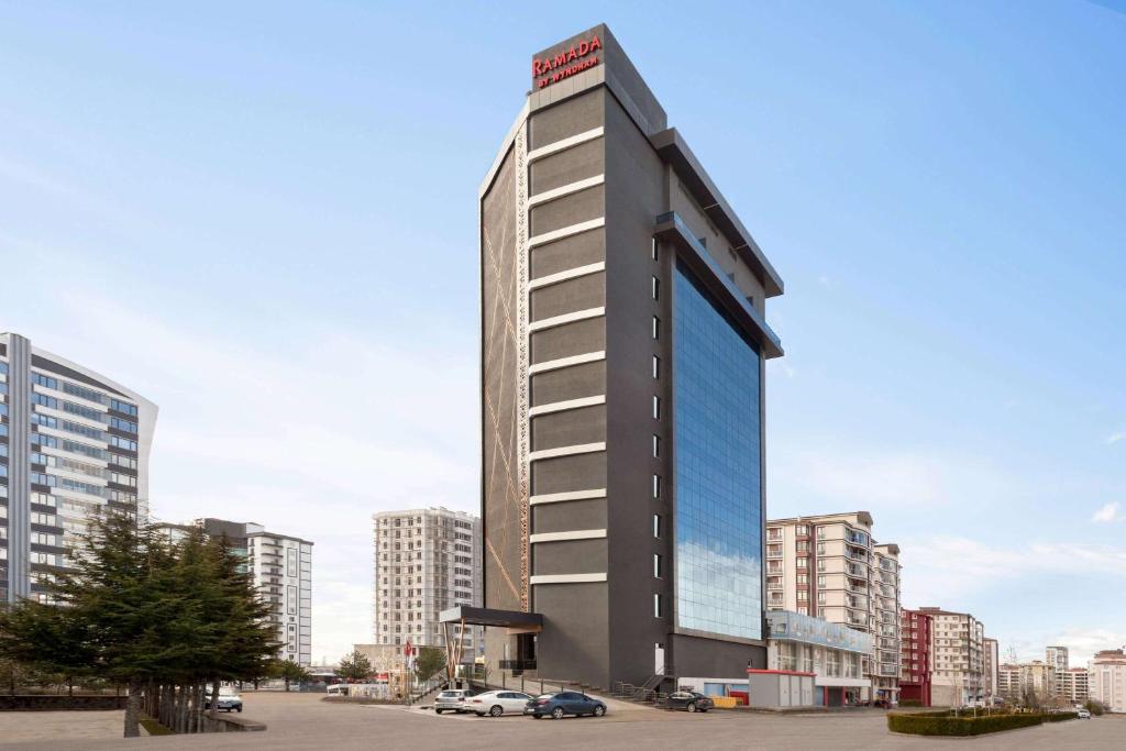 a tall building in the middle of a city at Ramada by Wyndham Nigde in Nigde