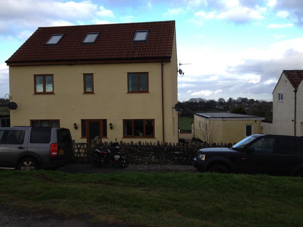 a house with two cars parked in front of it at Hillcrest Farm Bed & Breakfast in Redhill