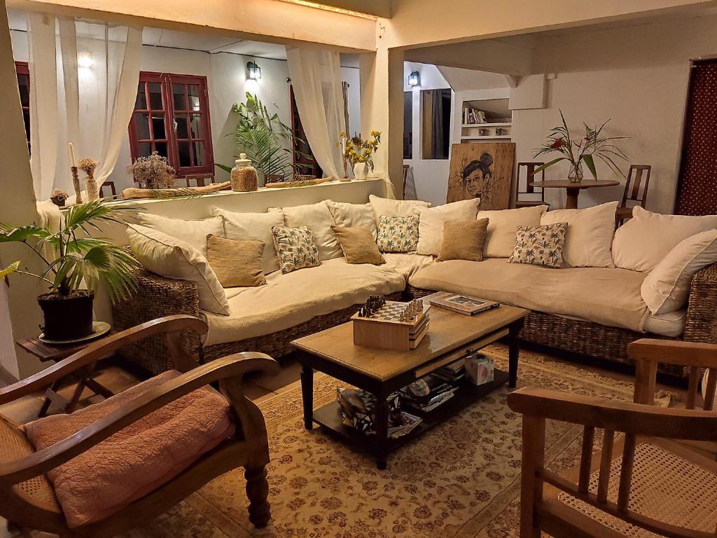 a living room with a couch and a table at Villa Laurina in Saint-Paul