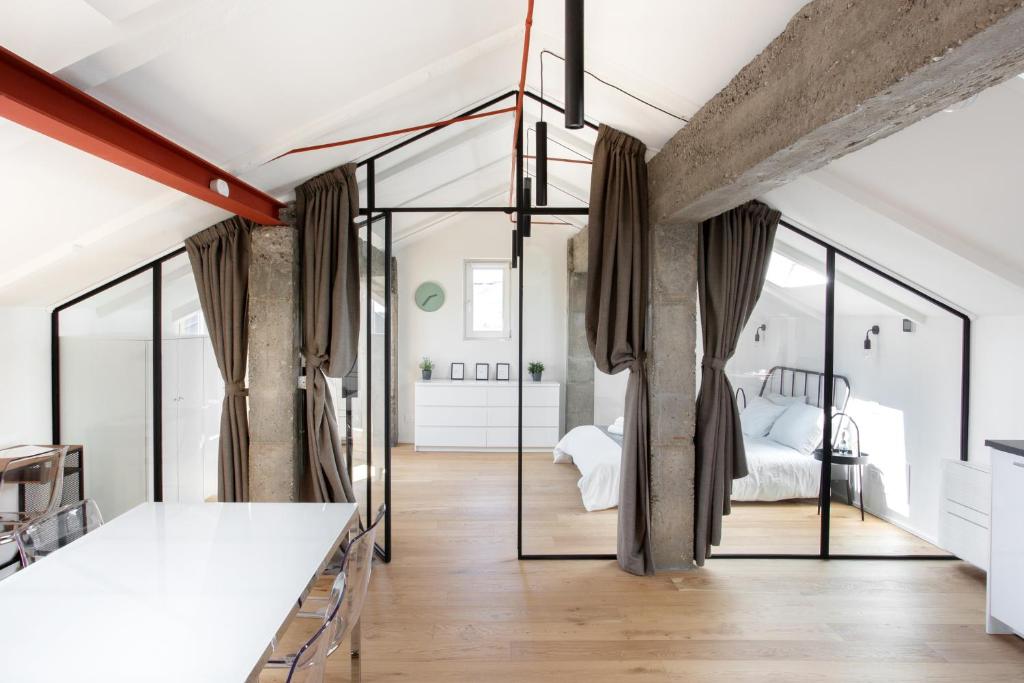 Mato Apartment Torino في تورينو: غرفة بسرير وجدران زجاجية