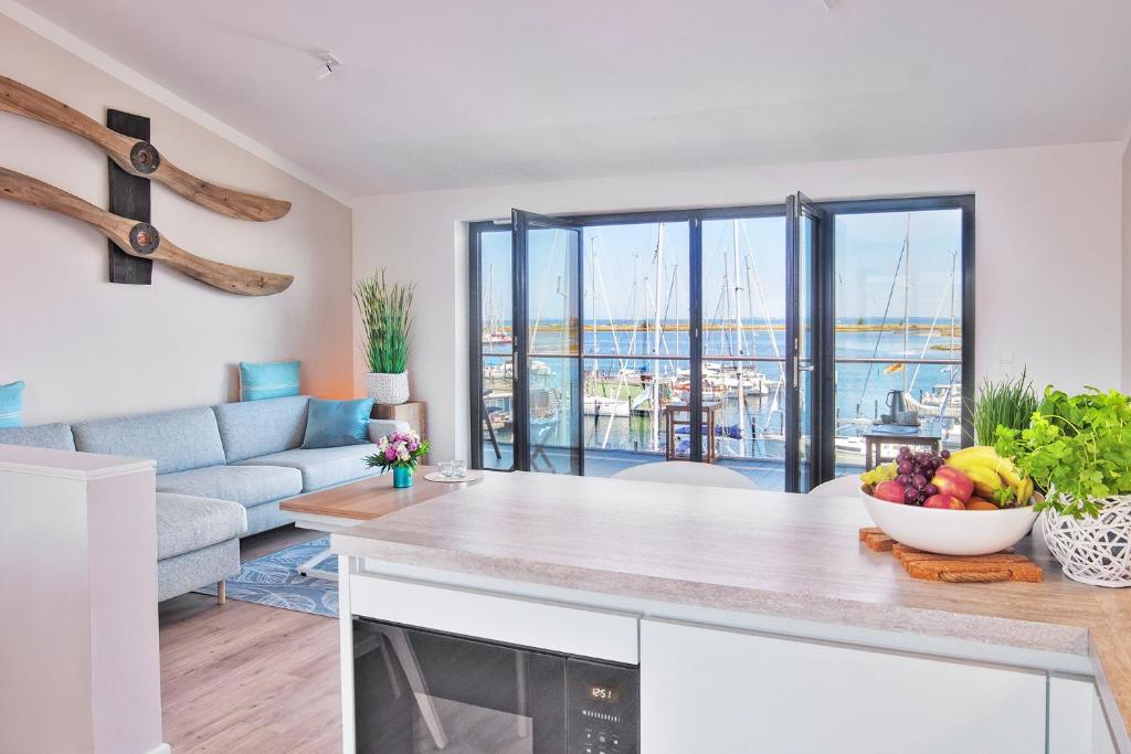 a kitchen and living room with a view of a harbor at Yachtenkieker in Heiligenhafen