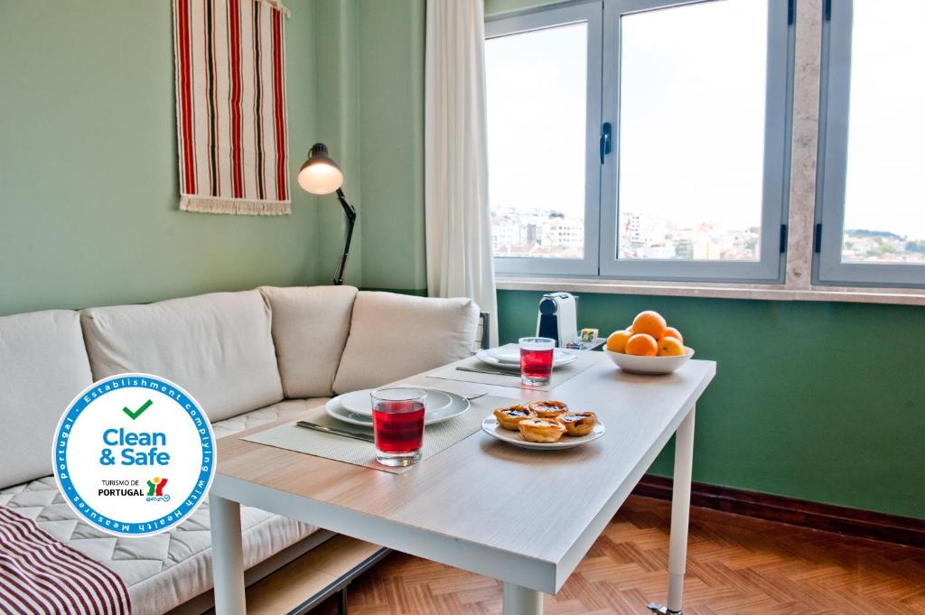 a living room with a white table with fruit on it at Expresso Martinis Mood Apartment 4C in Lisbon