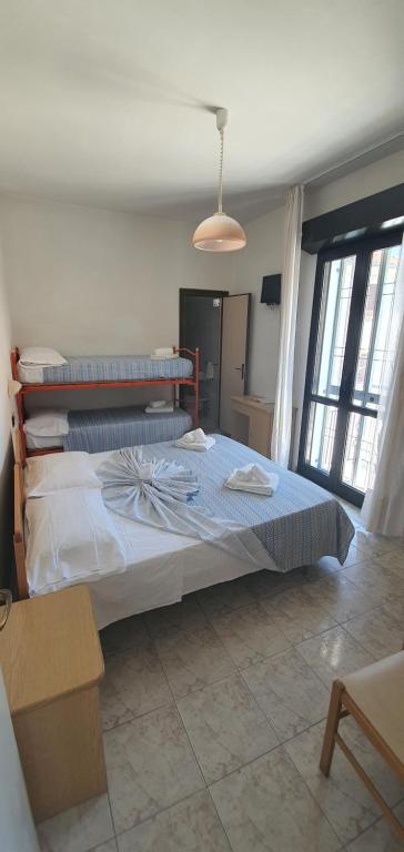 Postel nebo postele na pokoji v ubytování Hotel Vela Azzurra