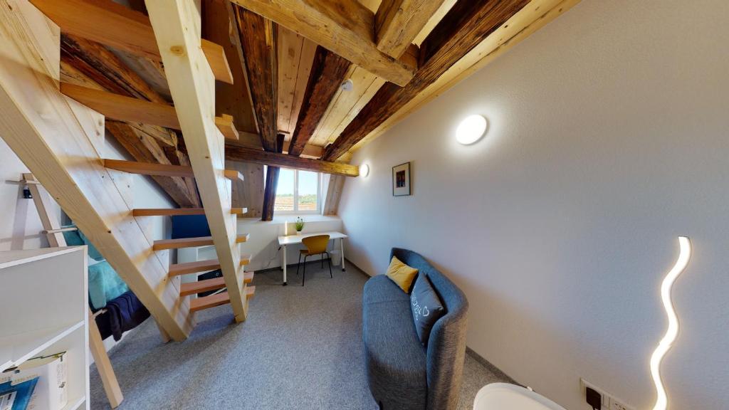 a room with a staircase and a couch and a table at Karl V - Geschichte leben im Herzen der Altstadt in Schwäbisch Hall