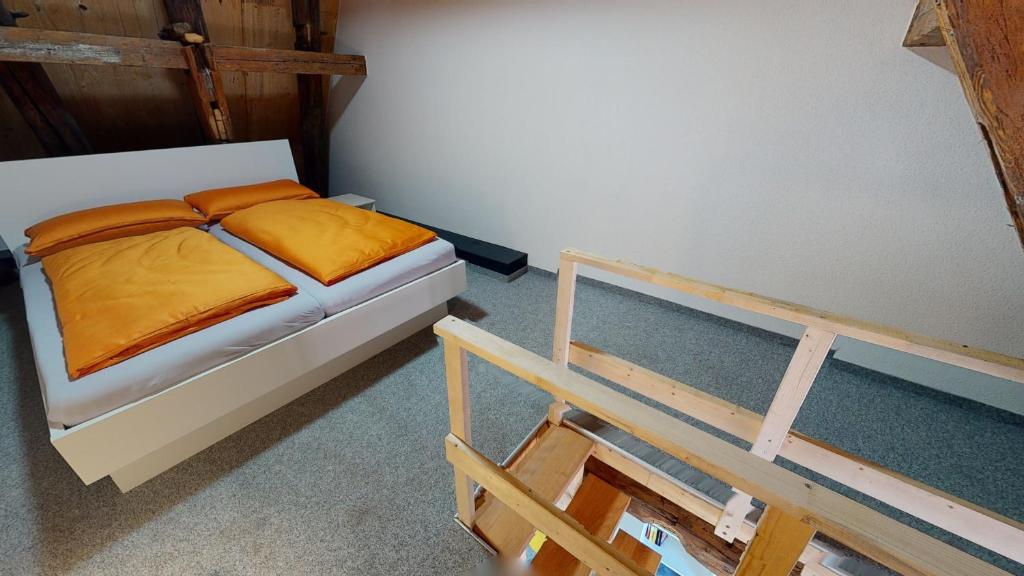 a bedroom with a bed with an orange comforter at Karl V - Geschichte leben im Herzen der Altstadt in Schwäbisch Hall