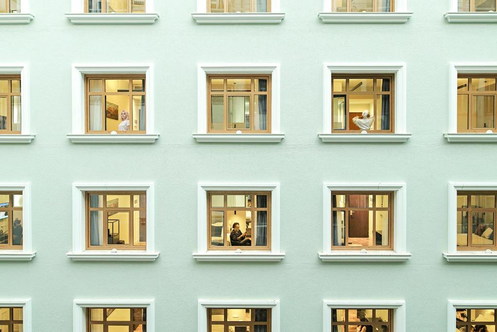 a facade of a blue building with windows at The Gem Society Hotel in Athens