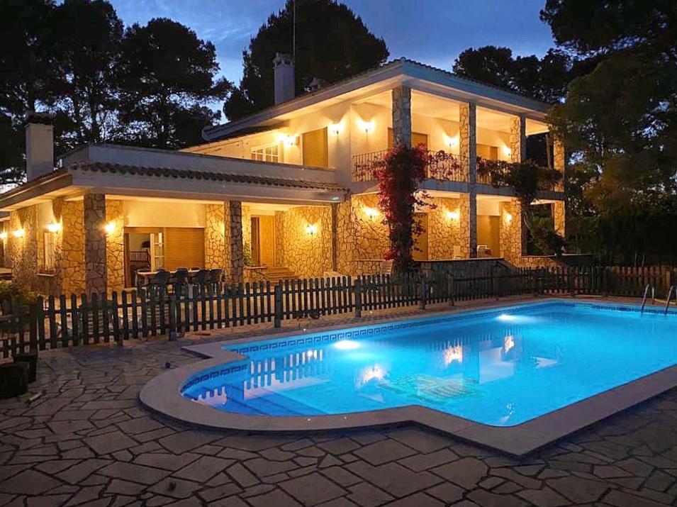 ein Haus mit Pool davor in der Unterkunft Villa Bella Cala in L'Ametlla de Mar