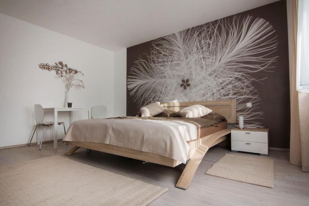a bedroom with a bed with a wall mural at Ferienwohnung Gehring Bad Krozingen in Bad Krozingen