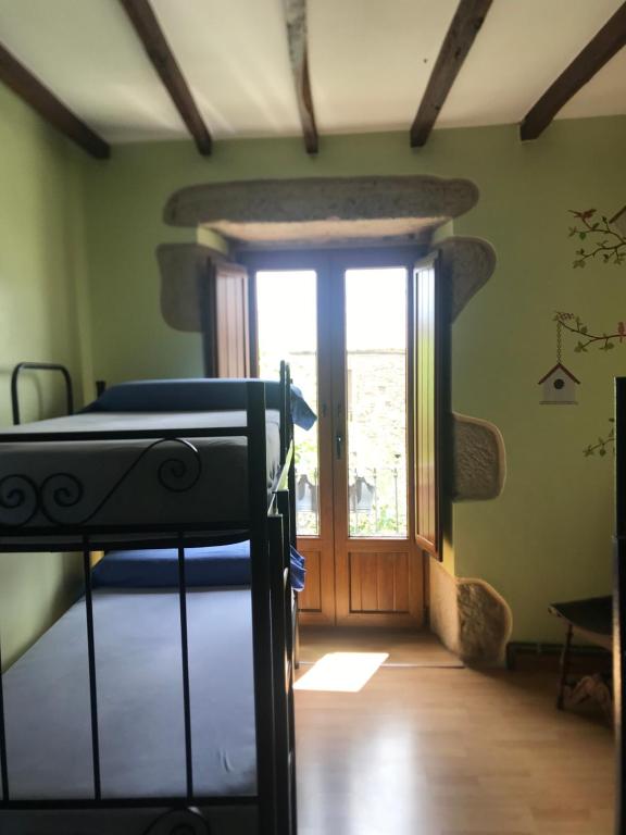 Postel nebo postele na pokoji v ubytování Pensión Albergue A Pedra