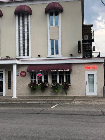 a building on the side of a street at Auberge Centre Ville in Saguenay