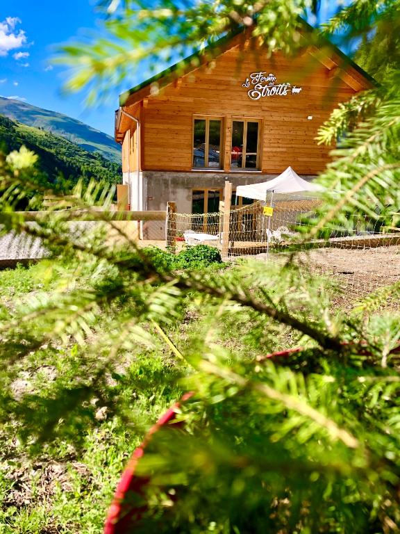 a log cabin with a sign on the side of it at La Ferme des Étroits in Valloire