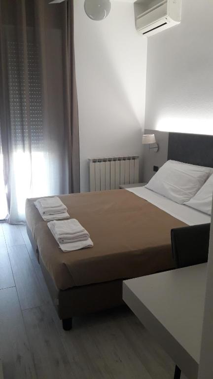 Postel nebo postele na pokoji v ubytování Hotel Cinzia