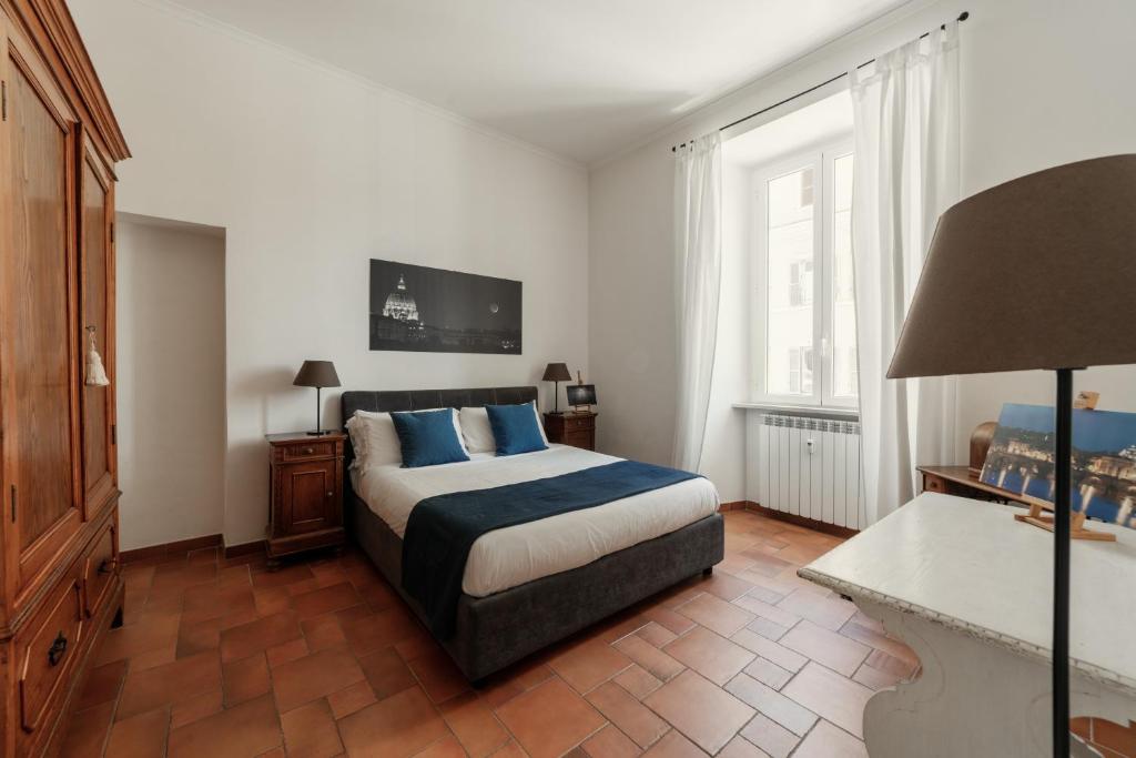a bedroom with a bed with blue pillows at B&B Domus Quiritum in Rome