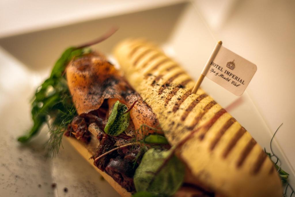 a piece of food in a box with a sandwich at Spa Hotel Imperial in Karlovy Vary